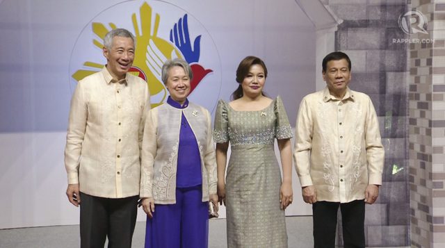 FILIPINIANA. Ho Ching wears a barong-like top over a bright purple ensemble. Rappler Screenshot  