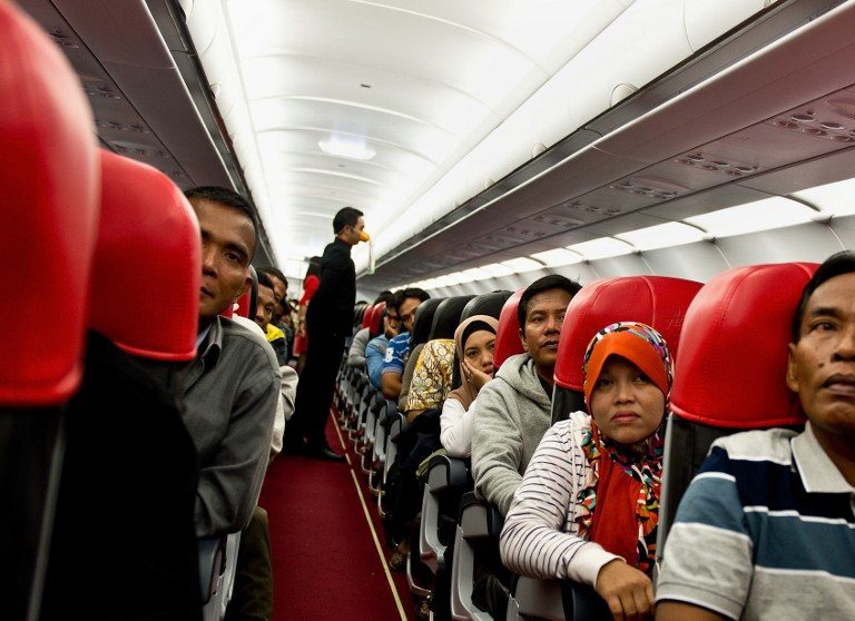 IS CHEAP NOT SAFE? Passengers watch as an AirAsia flight attendant (C-background) gives a safety demonstration while onboard a flight preparing to depart from Kuala Lumpur to Surabaya at Kuala Lumpur International Airport 2 (KLIA 2) in Sepang on December 29, 2014. Photo by AFP 