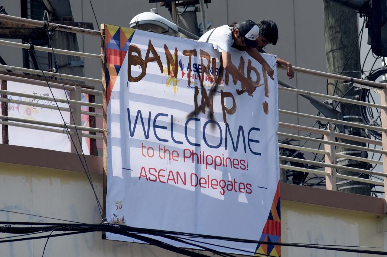 ANTI-TRUMP. Some protesters vandalize ASEAN posters to protest President Trump's visit. Photo by Angie de Silva/Rappler 