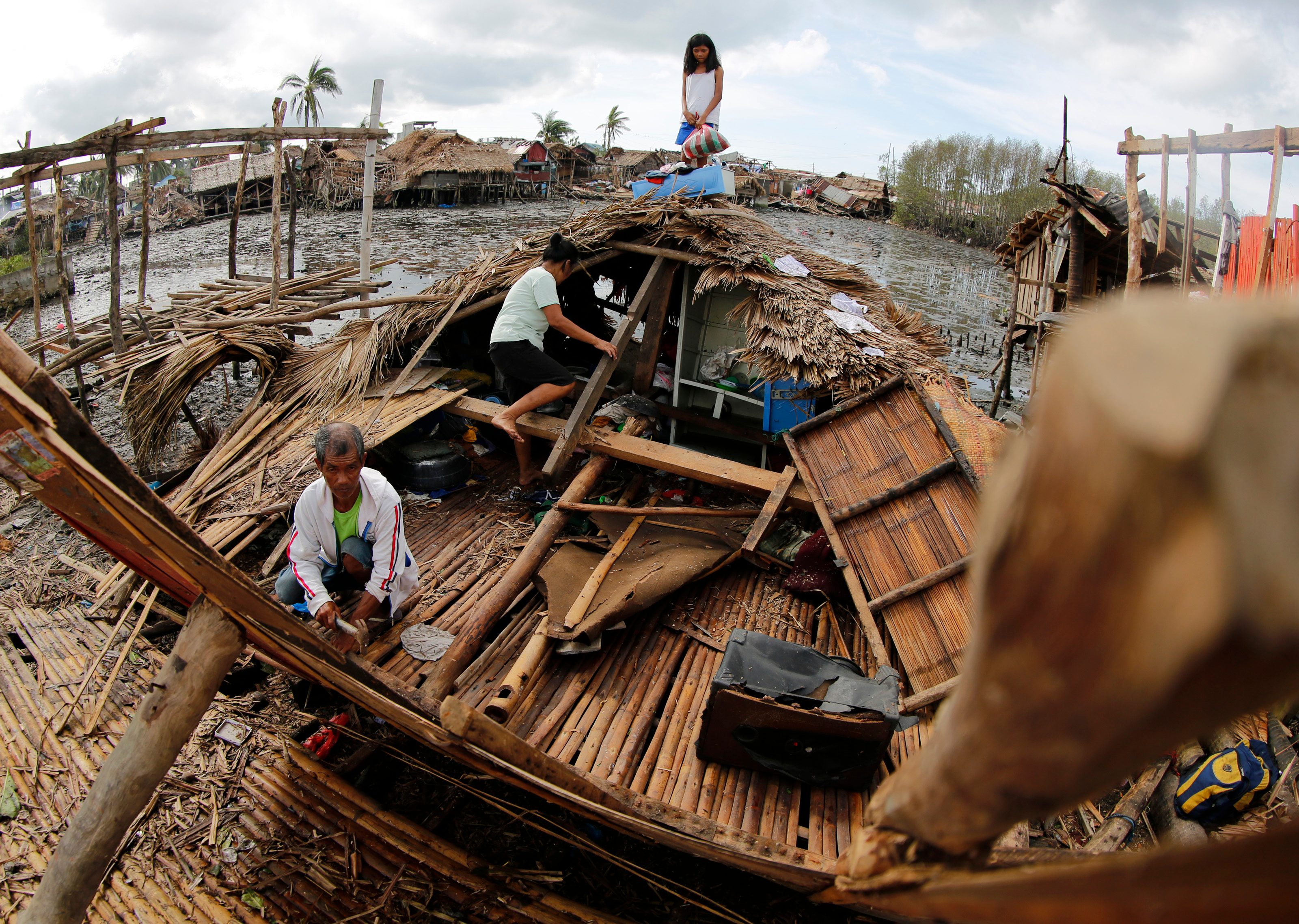 DAMAGED. Filipino villagers rebuild a damaged house in the typhoon-hit town of Magallanes, Sorsogon province, southern Manila, Philippines, on December 16, 2015. File photo by Francis R. Malasig/EPA  