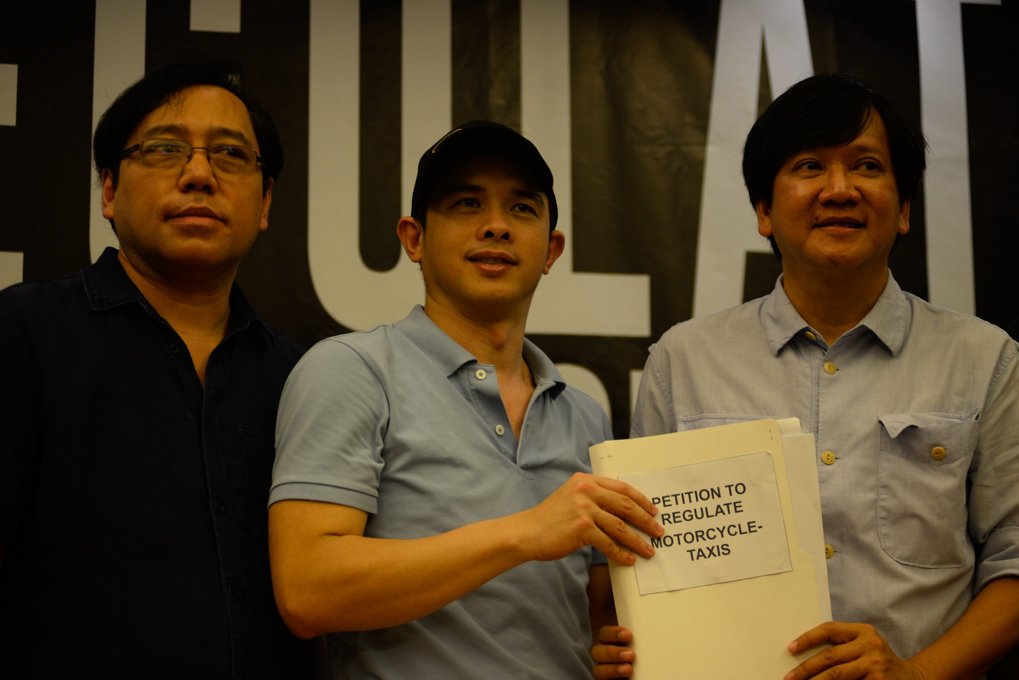 PRESENTING THE PETITION. Former LTFRB board member Atty. Ariel Inton (left) and Transport Watch convener George Royeca (center) hand over a petition with over 18,000 signatures to Rep. Winston Castelo (right). Photo by Maria Tan/Rappler 