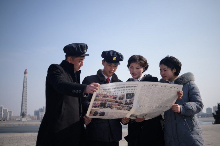 HIGH EXPECTATIONS. North Korean students read the Rodong Sinmun newspaper coverage of North Korea's leader Kim Jong-un visiting Vietnam for a summit in Hanoi with US President Donald Trump, on Kim Il-sung square Pyongyang on February 28, 2019.  Photo by Kim Won Jin/AFP   