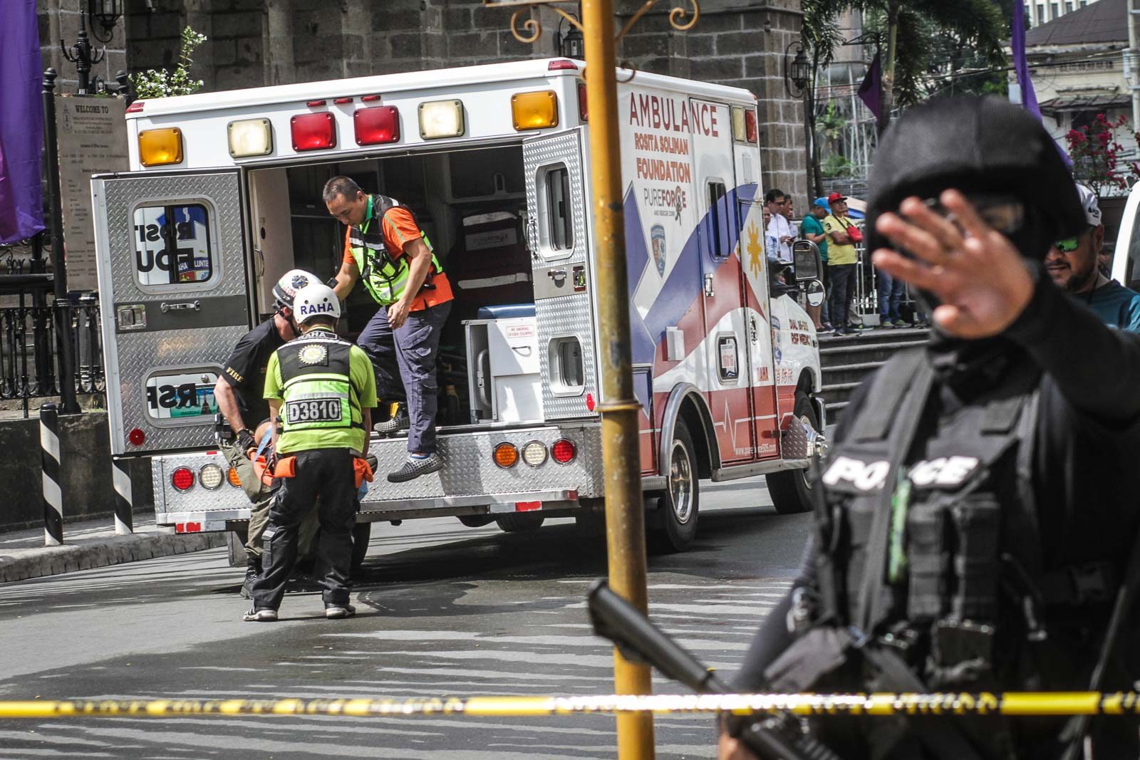 RESCUE. Paramedics carry a 'blast victim' into a waiting ambulance. 