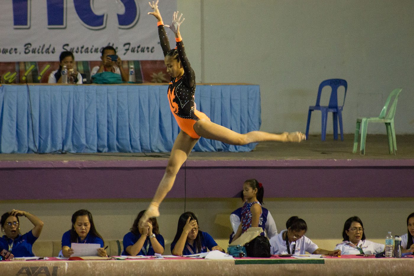 EXTRA FLIGHT. A gymnast performs her stunt in mid-air 