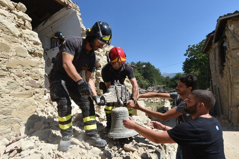 RECOVERY EFFORTS. Firefighters recover a bell from a damaged church in the village of Rio, some 10 kms from the central Italian village of Amatrice, on August 28, 2016, 4 days after a 6.2-magnitude earthquake struck the region, killing nearly 300 people. Photo by Alberto Pizzoli/AFP 
