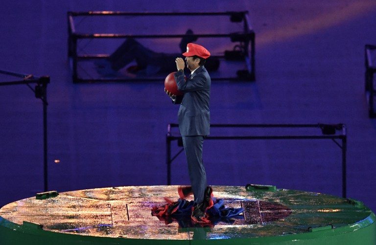 SUPER SHINZO. Japanese Prime Minister Shinzo Abe, dressed as Super Mario, holds a red ball during the closing ceremony of the Rio 2016 Olympic Games at the Maracana stadium in Rio de Janeiro on August 21, 2016. Philippe Lopez/AFP 