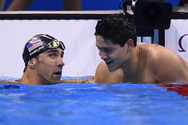 FRIENDS. USA's Michael Phelps (L) and Singapore's Schooling Joseph talk after competing in the Men's 100m Butterfly Final during the swimming event at the Rio 2016 Olympic Games at the Olympic Aquatics Stadium in Rio de Janeiro on August 12, 2016. Gabriel Bouys/AFP 