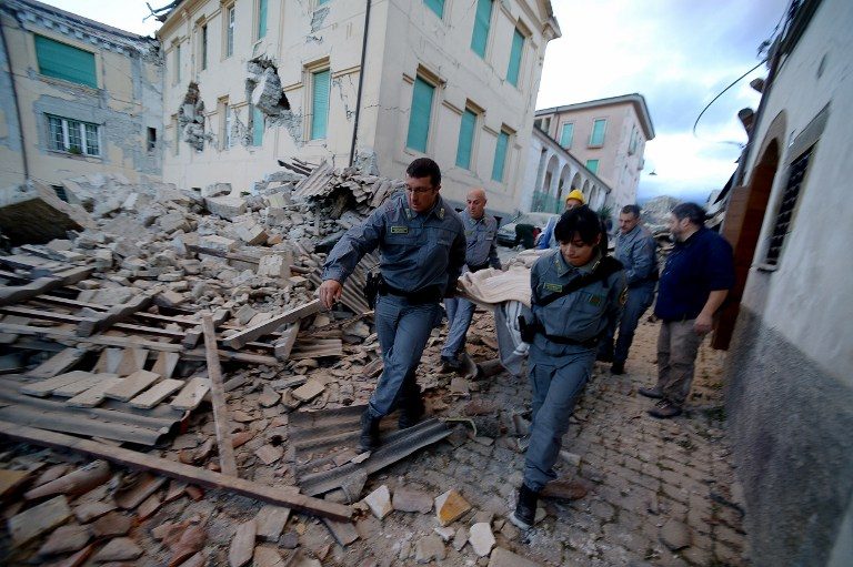 EMERGENCY. Rescuers carry a man from the rubble after a strong earthquake hit Amatrice on August 24, 2016. Filippo Monteforte/AFP  