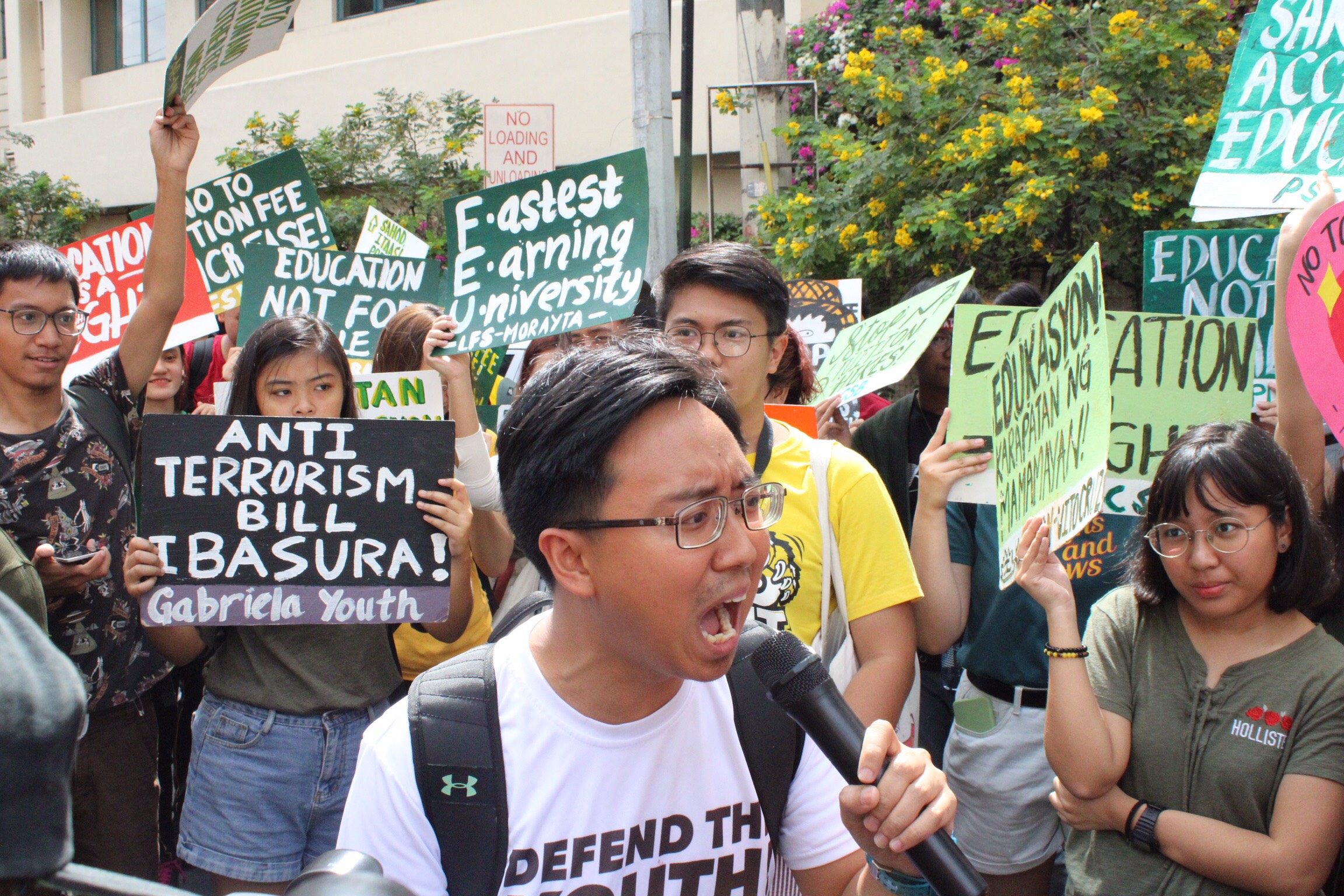DEFEND. National Union of Students of the Philippines (NUSP) President Raoul Manuel raise his concerns for the proposed tuition fee hike in front of Far Eastern University (FEU) gate. Photo by Kristine Vega 