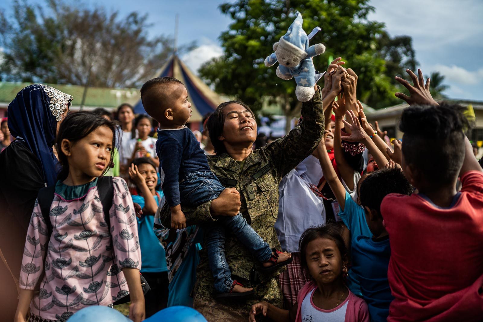 NEW REALITY. A soldier catches a stuffed toy for a child during the Festival of Love and Peace in Mohammad Ajul, Basilan, on October 4, 2019.  Photo by Martin San Diego