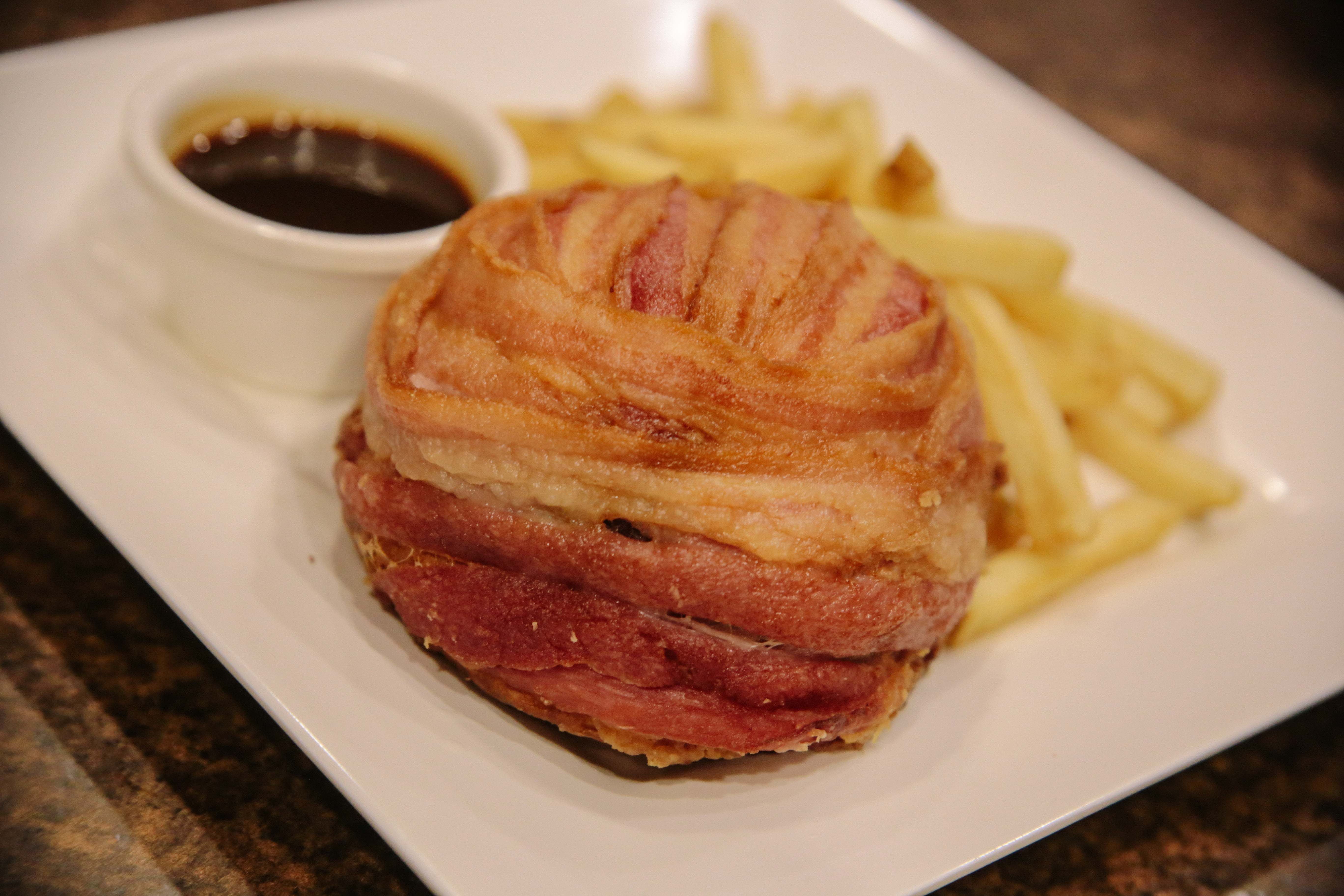 Deep-fried bacon-wrapped burger with barbecue rum sauce and fries on the side. Photo by Paolo Abad/Rappler 