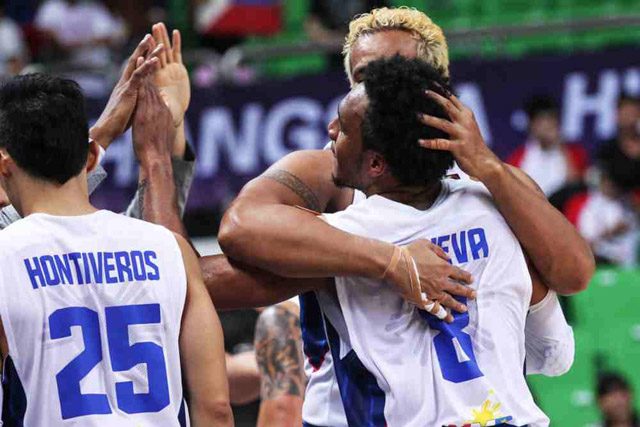 HUG. Calvin Abueva and Asi Taulava share a warm hug as the Philippines rejoices. Photo from FIBA 