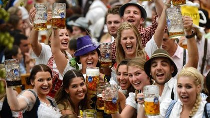 CHEERS. Visitors wearing traditional Bavarian clothes raise their beers in a festival tent at the start of the Oktoberfest beer festival at the Theresienwiese in Munich, southern Germany. The world's biggest beer festival Oktoberfest will run until October 7, 2012. Photo by AFP