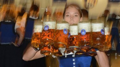 BALANCING ACT. A waitress carries beer mugs in a festival tent after the start of the Oktoberfest beer festival. Photo by AFP.