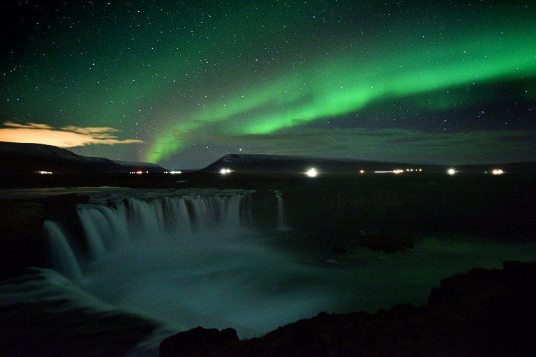 NORTHERN LIGHST. The aurora borealis is seen over Godafoss waterfall, in the municipality of Thingeyjarsveit, east of Akureyri, in northern Iceland on October 14, 2018. Photo by Mariana Suarez/AFP  