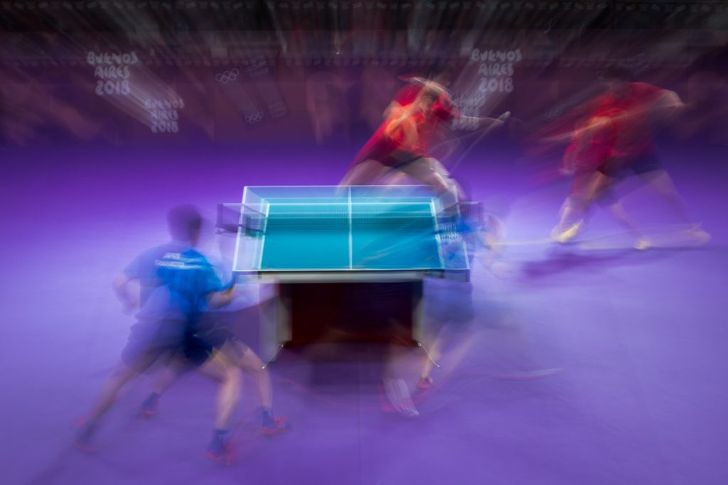 FAST PACE. A zoom blur effect of Miu Hirano JPN playing alongside Tomokazu Harimoto JPN against Chuqin Wang CHN and Yingsha Sun CHN in the Table Tennis Mixed International Team Gold Medal Team Match in the Table Tennis Arena, Tecnopolis Park during the Youth Olympic Games in Buenos Aires, Argentina, on October 15, 2018. Photo Simon Bruty/OIS/IOC  