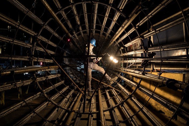 BUILD, BUIL, BUILD. A worker uses an acetylene torch to cut through metal bars at a construction site in Manila on October 13, 2018. Photo by Noel Celis/AFP 