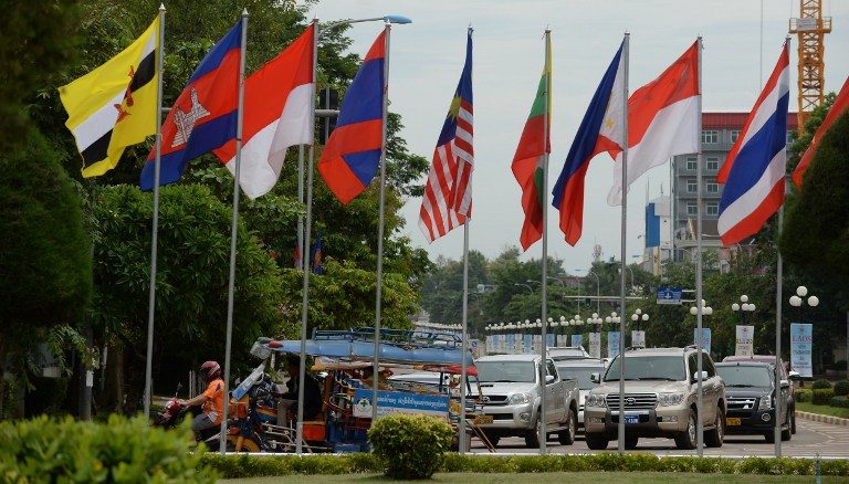 ASEAN COLORS. Cars and tuk-tuk ride past a row of ASEAN member countries' flags in the Laos capital of Vientiane on July 23, 2016, during the country's hosting of the 49th annual ministerial meeting of the South East Asian Nations (ASEAN). Hoang Dinh Nam/AFP 