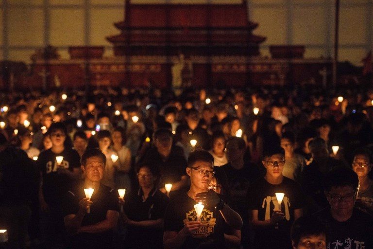REMEMBERING THE VICTIMS. People hold candles during a vigil in Hong Kong on June 4, 2018, to mark the 29th anniversary of the 1989 Tiananmen crackdown in Beijing. Photo by Anthony Wallace/AFP  