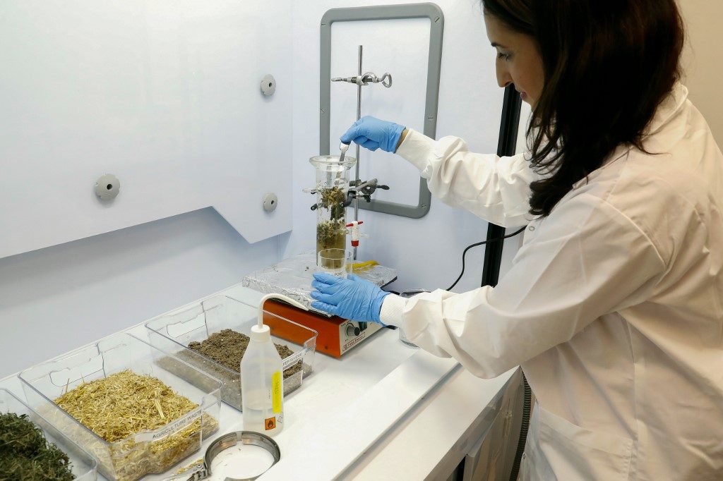 RECYCLING WASTE. Professor Hadas Mamane produces Ethanol from waste at the laboratory of Tel Aviv University (TAU) in the Israeli coastal city, on July 8, 2020. Photo by Jack Guez/AFP  