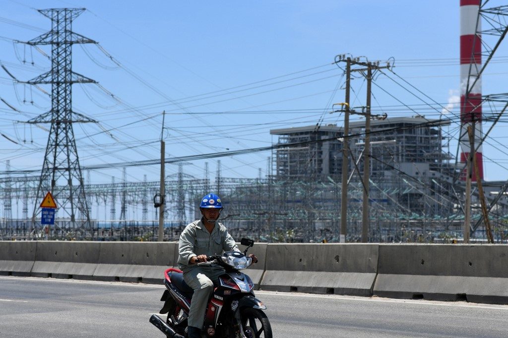 COAL POWER. A motorist rides past the Vinh Tan coal power plant in southern Vietnam's Binh Thuan province on April 23, 2019. Photo by Manan Vatsyayana/AFP 