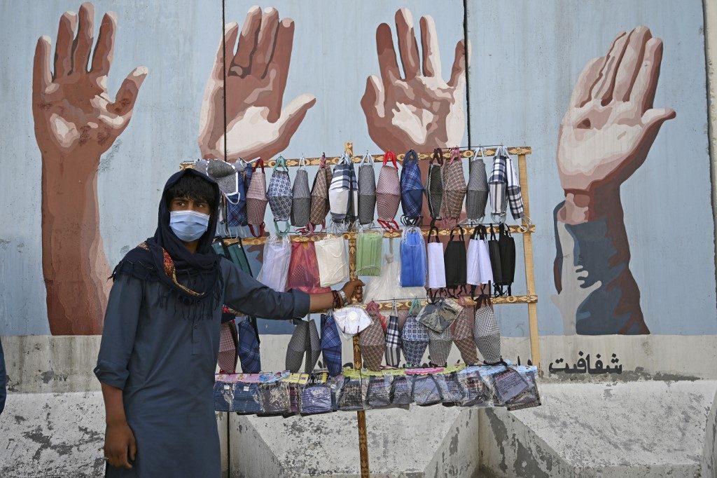 FOR SALE. A street vendor selling face masks waits for customers in Kabul, Afghanistan, on June 18, 2020. Photo by Wakil Kohsar/AFP 
