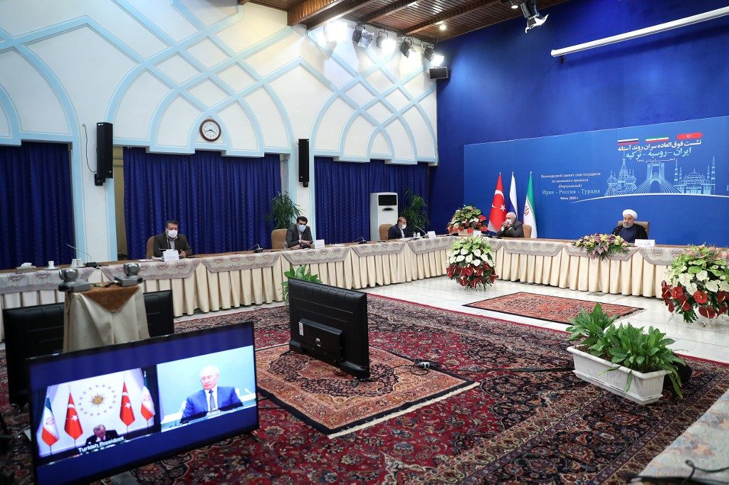 COOPERATION. A handout picture provided by the Iranian presidency on July 1, 2020, shows President Hassan Rouhani (R), accompanied by the Foreign Minister Mohmmad Javad Zarif (2-R) who is mask-clad due to the coronavirus pandemic and other officials, attending by video conference a trilateral meeting with the leaders of Turkey and Russia on the topic of Syria, in the Iranian capital Tehran. AFP PHOTO/HO/IRANIAN PRESIDENCY 
