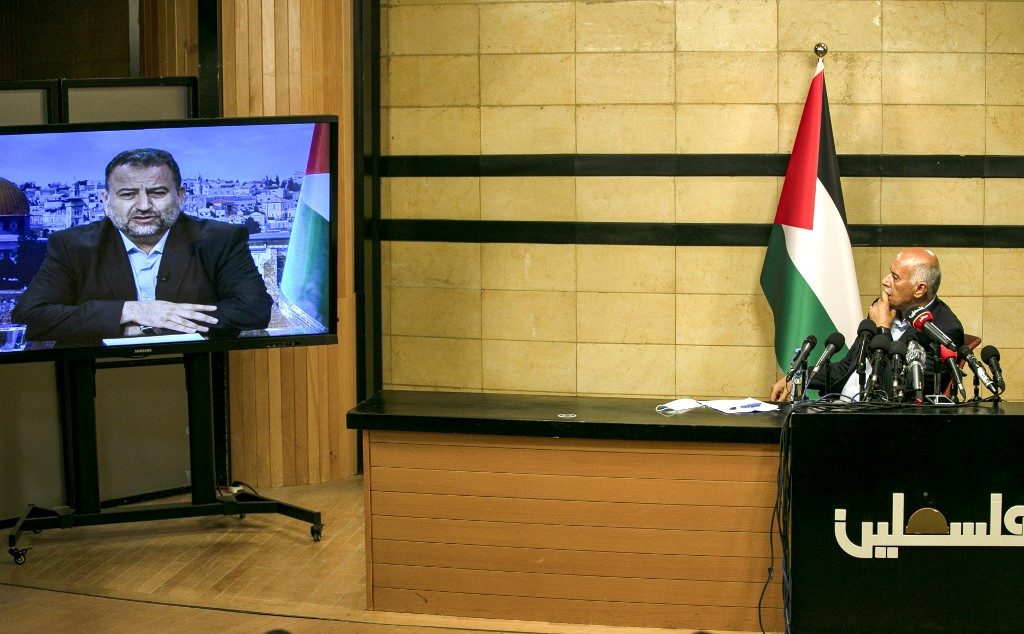 UNITED. Senior Fatah official Jibril Rajoub, in the West Bank city of Ramallah, attends by video conference a meeting with deputy Hamas chief Saleh Arouri (on screen from Beirut) discussing Israel's plan to annex parts of the Israeli-occupied West Bank, on July 2, 2020. Photo by Abbas Momani/AFP 