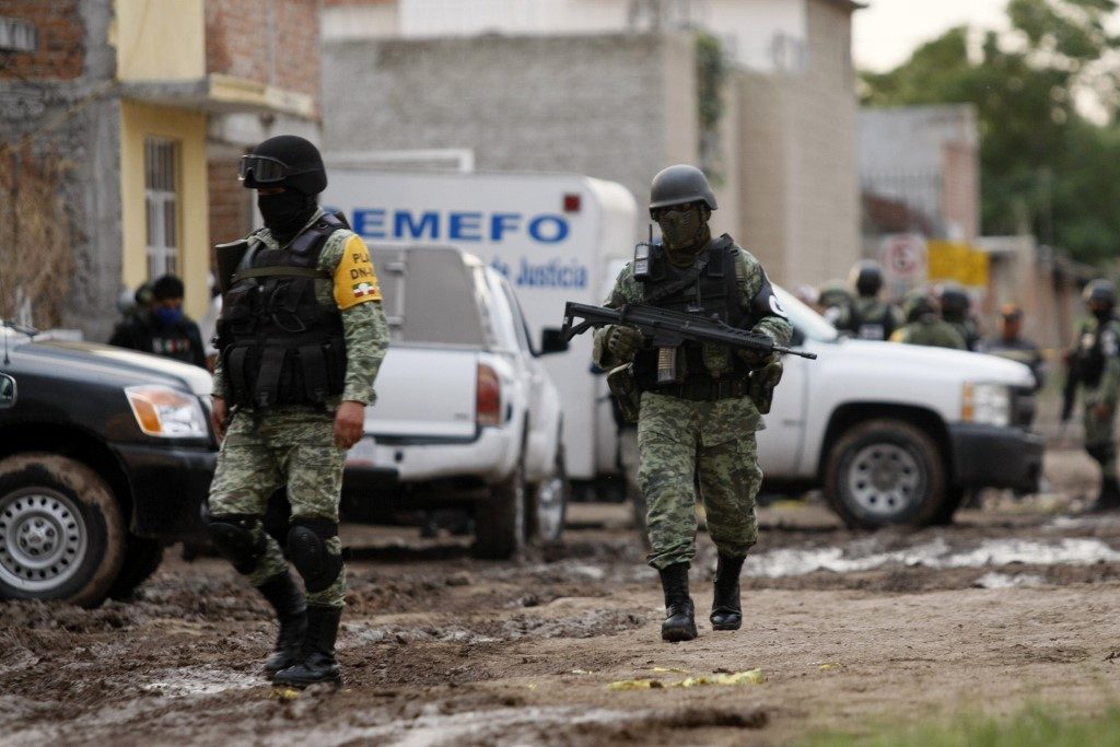 CRIME SCENE. Members of the National Guard walk near the crime scene where 24 people were killed in Irapuato, Guanajuato state, Mexico, on July 1, 2020.  Photo by Mario Armas/AFP 