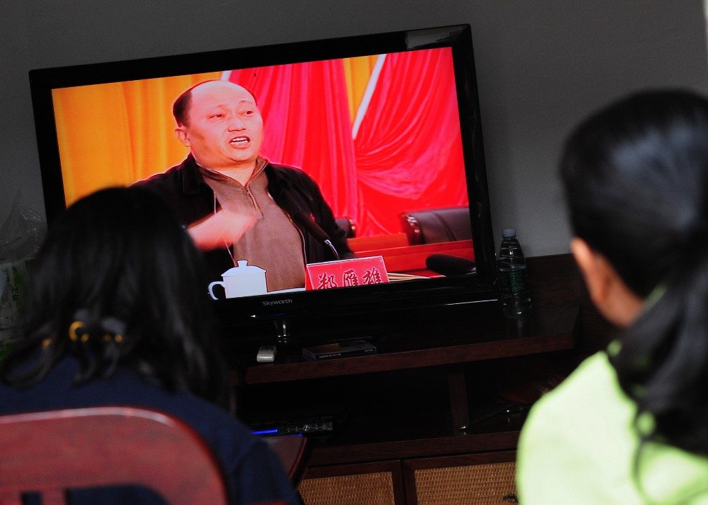 APPOINTMENT. This file photo taken on December 20, 2011, shows Zheng Yanxiong, then-Communist Party Secretary of Shanwei prefecture, speaking on television as villagers watch the broadcast in Wukan, Guandong province. China has appointed a hardliner involved in a clamp down against protests on the mainland as the head of Hong Kong's new security agency on July 3, 2020.  File photo by Mark Ralston/AFP 