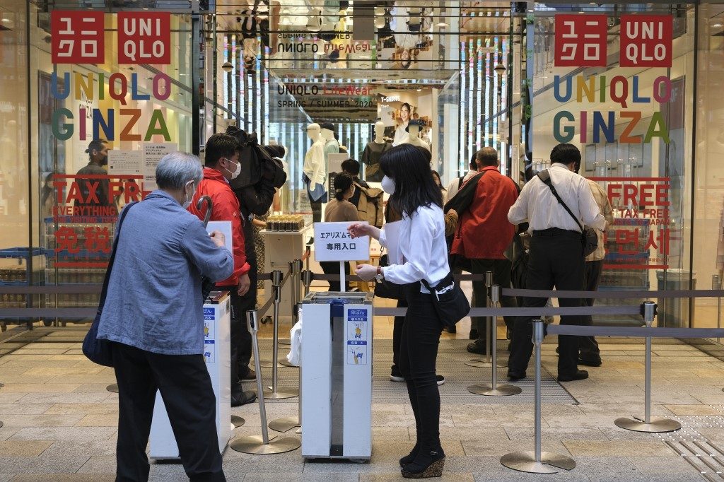 UNIQLO. Customers wait in a queue outside a Uniqlo store in Tokyo's Ginza shopping district on June 19, 2020. Photo by Kazuhiro Nogi/AFP 