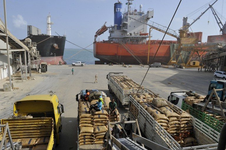 BUSTLING. This file photo taken on March 27, 2016 shows workers loading goods at the port of Djibouti. Photo by Simon Maina/AFP 