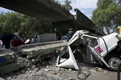 QUAKE DAMAGE. Firefighters work to remove a bus damaged by a bridge which collapsed, following a strong quake that hit Mexico on March 20, 2012. A powerful 7.6-magnitude earthquake struck southwest Mexico, causing residents in the capital several hundred miles away to rush out onto the streets but no immediate reports of serious damage. AFP PHOTO/RONALDO SCHEMIDT