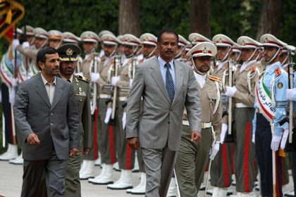 Iranian President Mahmoud Ahmadinejad (L) and his Eritrean counterpart Issaias Afeworki (front R) review the honour guard upon the latter's arrival at Tehran on May 19, 2008. Both Iran and Eritrea are part of the Committee to Protect Journalists (CPJ) list of most censored countries, released May 2, 2012. AFP PHOTO/ATTA KENARE