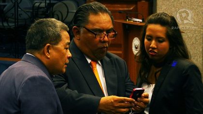 CORONA'S INSTRUCTION. Defense counsel Judd Roy (center) says Corona's instruction was that he will respond to allegations against him under oath. Photo by Emil Sarmiento 