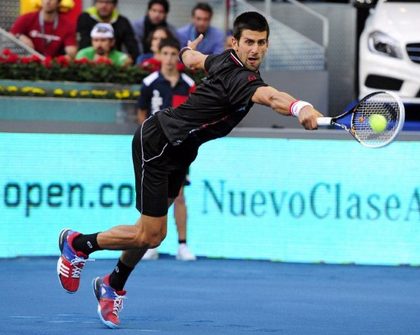 PLAYING ON BLUE CLAY. Serbian Novak Djokovic returns a ball to Spanish Daniel Jimeno-Traver during their tennis match of the Madrid Masters on May 8, 2012 at the Magic Box (Caja Magica) sports complex in Madrid. Djokovic won 6-2, 2-6, 6-3. AFP photo/Javier Soriano