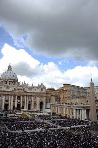 Faithful stand at St Peter's square during the Easter Holy Mass on April 8, 2012 at The Vatican. Photo by AFP