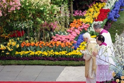 In spring weather, watched by some 100,000 faithful crammed into the square, Pope Benedict XVI made his way slowly to the altar erected in front of the basilica, surrounded by beds of fresh flowers flown in from the Netherlands. Photo by AFP