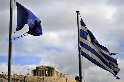 IN TATTERS. Ripped EU and Greek flags flutter in Athens on February 9, 2012. AFP photo / Louisa Goiliamaki