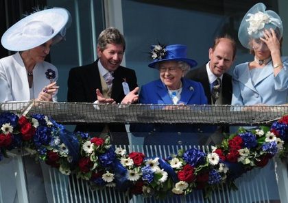 Britain's Queen Elizabeth II (C) standing next to Prince Edward, Earl of Wessex (2R) smiles from the royal balcony as she looks down on the winning horse in the Derby race on Derby Day, the second day of the Epsom Derby horse racing festival, at Epsom in Surrey, southern England, on June 2, 2012 the first official day of Britain's Queen Elizabeth II's Diamond Jubilee celebrations. Princess Michael of Kent is at (L). AFP PHOTO / CARL COURT