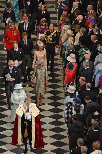 Britain's Queen Elizabeth II walks behind the Sword of State followed by members of the royal family including Prince Charles, Prince of Wales, and Camilla, Duchess of Cornwall, Prince William and Catherine, Duchess of Cambridge, during a national service of thanksgiving for the Queen's Diamond Jubilee at St Paul's Cathedral in London on June 5, 2012. Queen Elizabeth II attended the final day of celebrations for her diamond jubilee Tuesday, but the pomp and splendor were marred by the absence of her husband Prince Philip after he was hospitalized. AFP PHOTO / POOL / JEFF J MITCHELL