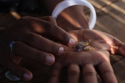 Celine, 24, displays sapphires her mother found a day before in the river of Ilakaka, Southern Madagascar. In 1998, a seam of high-quality sapphires was found in the Ilakaka river valley, about 700 kilometres (430 miles) south of from the capital Antananarivo. AFP PHOTO