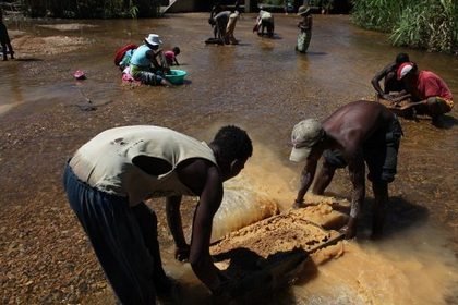 Men wash rocks from a mine in the river of Ilakaka, Southern Madagascar. In 1998, a seam of high-quality sapphires was found in the Ilakaka river valley, about 700 kilometres (430 miles) south of from the capital Antananarivo. People from across the country rushed to search for the stones, inflating the population from a few dozen to about 50,000. AFP PHOTO