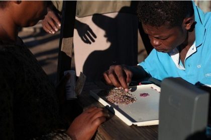 A picture taken on March 12, 2012 shows a man looking at sapphires in the market of Ilakaka, Southern Madagascar. AFP PHOTO