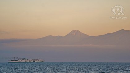 TOWERING GIANT. A huge shipping vessel passing by the Davao Gulf was dwarfed by the towering Mt. Apo. Photo from Karlos Manlupig