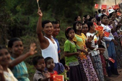 CAMPAIGN SEASON. Supporters stand on the side of a road waving flags as Myanmar opposition leader Aung San Suu Kyi travels to the constituency where she stands as a candidate in the April 1 parliament. Photo from AFP