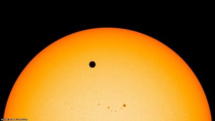 The planet Venus (large black dot) as seen during its transit infront of the Sun on June 6, 2012. Sunspots AR1493 and AR1496 are also seen in the image (smaller dots). Image courtesy of NASA/ Solar Dynamics Observatory.