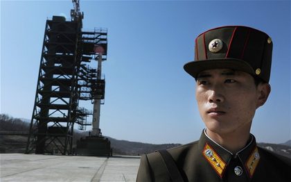 READY FOR LIFTOFF. A North Korean soldier stands guard in front of an Unha-3 rocket at Tangachai -ri space center on April 8, 2012. North Korea has confirmed their intention to launch the rocket this week (between April 12-16) despite international condemnations. AFP Photo/Pedro Ugarte