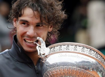 VICTORY. Spain's Rafael Nadal celebrates with his trophy after winning against Serbia's Novak Djokovic their Men's Singles final tennis match during the French Open tennis tournament at the Roland Garros stadium, on June 11, 2012 in Paris. Photo by AFP 