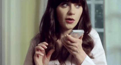 "REMIND ME TO CLEAN UP." Zooey Deschanel spends a rainy day in with Siri.